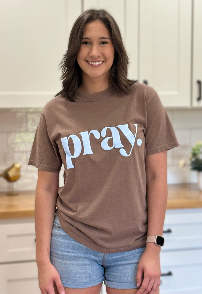 “Pray.” faith graphic tee with soft cotton fabric, textured print, and relaxed fit.