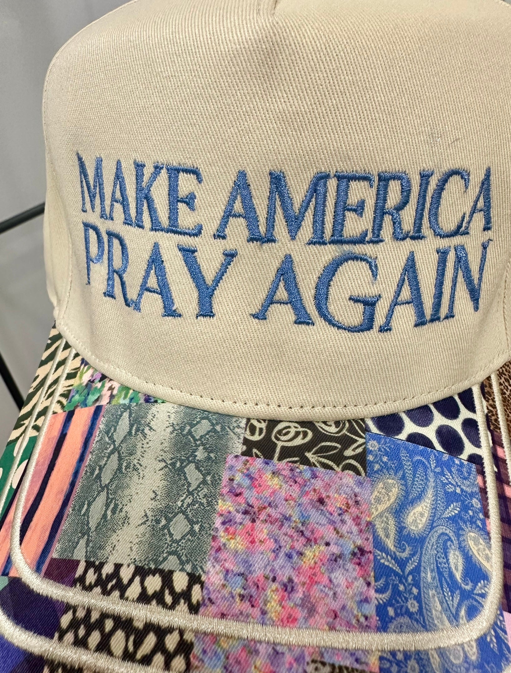 Cream and multicolor patchwork trucker hat with ‘Make America Pray Again’ embroidery — faith-inspired accessory from Justyna Grace Boutique