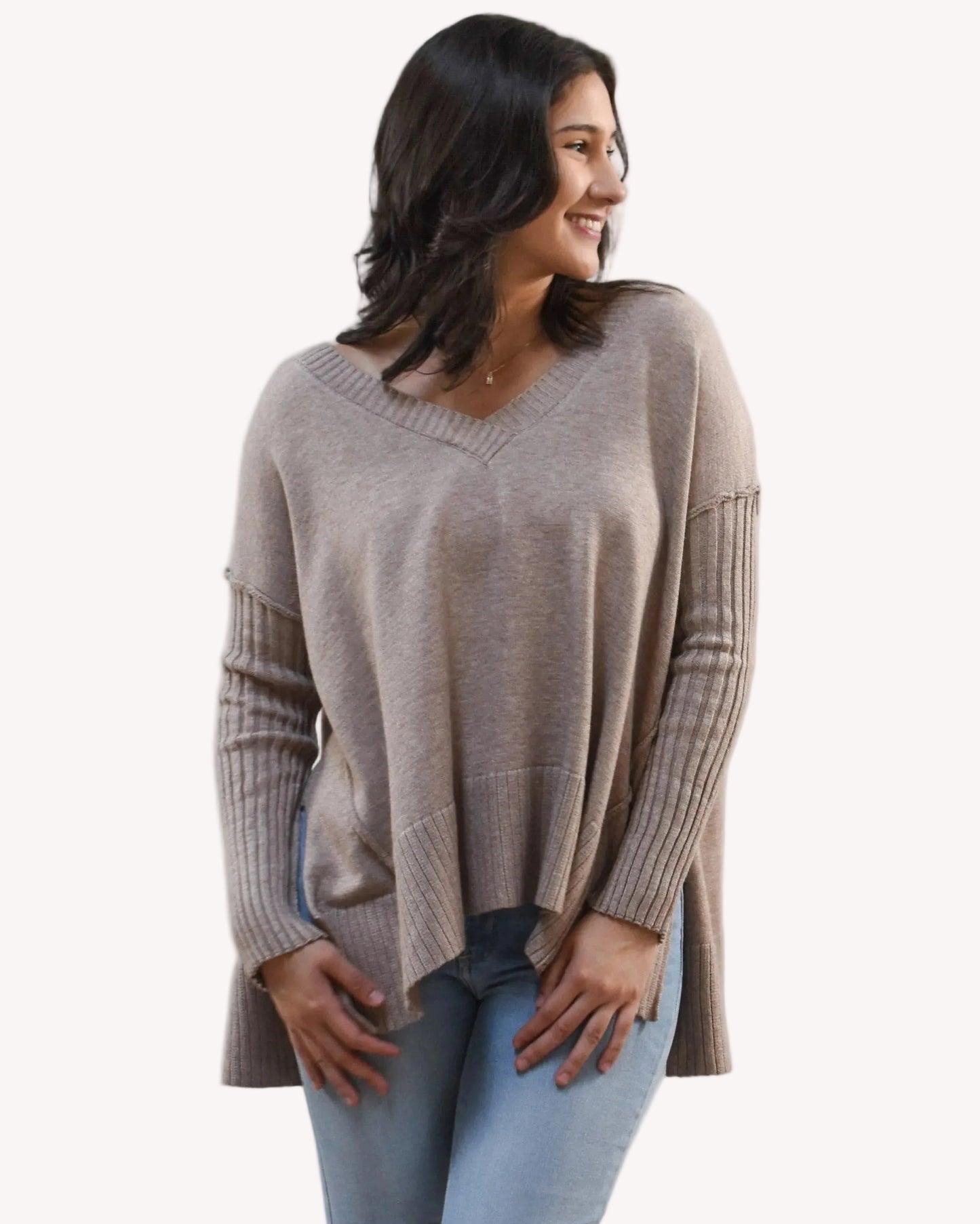 Woman wearing a beige sweater on a white background
