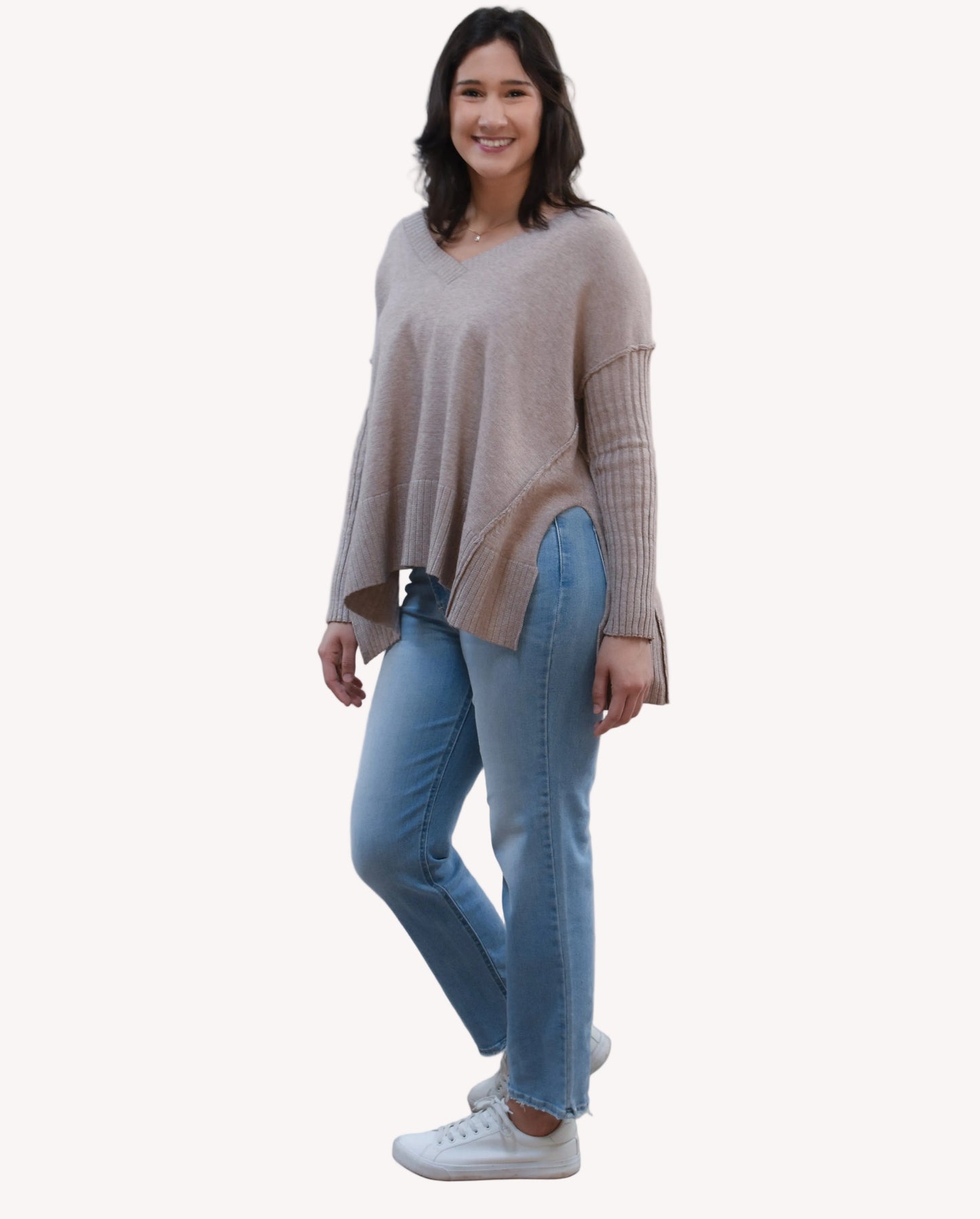 Pure Ease Ribbed V-Neck Tunic on soft linen background, featuring a smooth viscose-nylon knit and long relaxed silhouette.