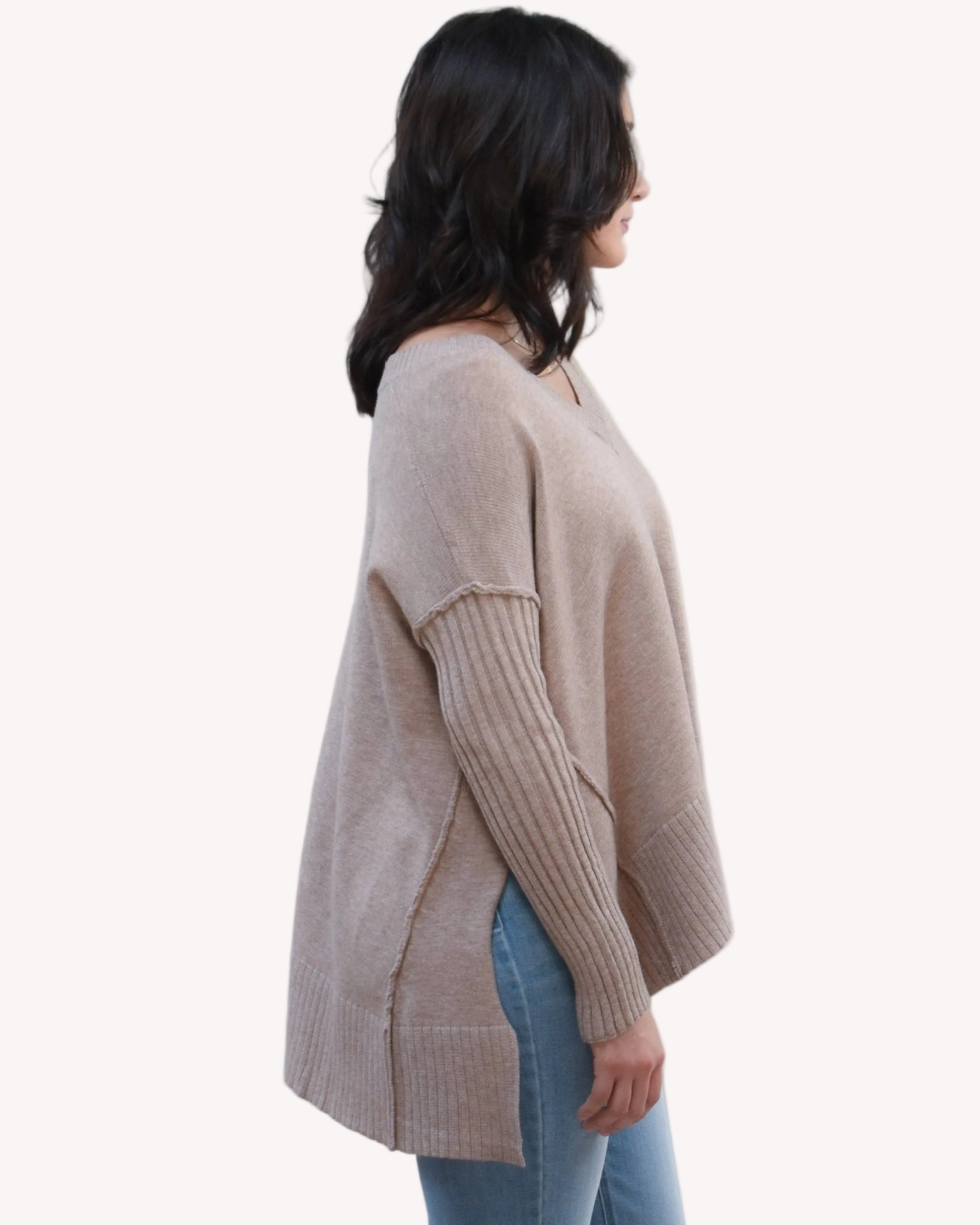 Pure Ease Ribbed V-Neck Tunic on soft linen background, featuring a smooth viscose-nylon knit and long relaxed silhouette.