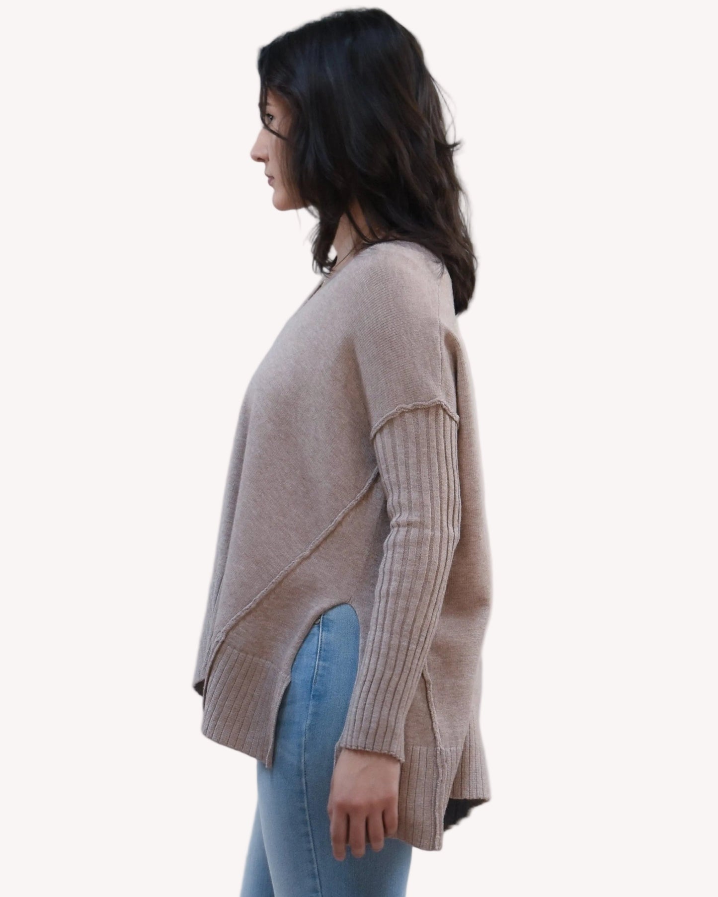 Pure Ease Ribbed V-Neck Tunic on soft linen background, featuring a smooth viscose-nylon knit and long relaxed silhouette.