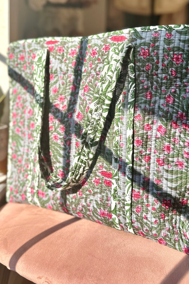 Quilted Garden Tote with boho floral pattern in moss green, pink, and blue, handcrafted from quilted cotton with zipper closure and interior pocket, ethically made in India by fair-trade artisans.
