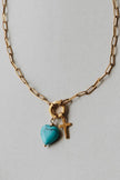 Radiant Heart Necklace — turquoise heart pendant with 14K gold-plated cross charm on waterproof chain from Justyna Grace Boutique.