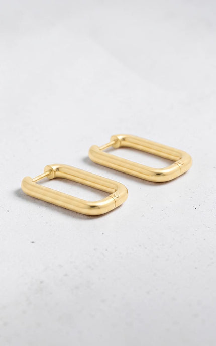 Detailed view of rich gold luster on sleek rectangle huggie hoops