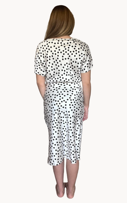 Woman wearing a polka dot dress on a white background