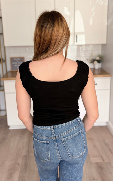 Back of ribbed cotton-spandex tank displaying ruched strap construction and quality seaming