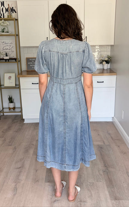Soft 100% Tencel maxi dress with a V-neckline and puff sleeves, showcasing the sustainable fabric's natural drape and silky sheen.