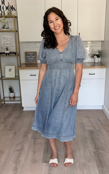 A model wearing a soft, flowing Tencel maxi dress with a V-neckline, embodying a romantic and effortlessly chic summer style.