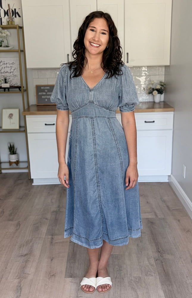Front view of a 100% Tencel maxi dress in a soft feminine silhouette with a V-neckline and romantic puff sleeves.