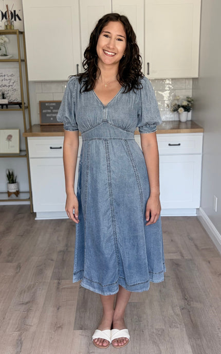 Front view of a 100% Tencel maxi dress in a soft feminine silhouette with a V-neckline and romantic puff sleeves.