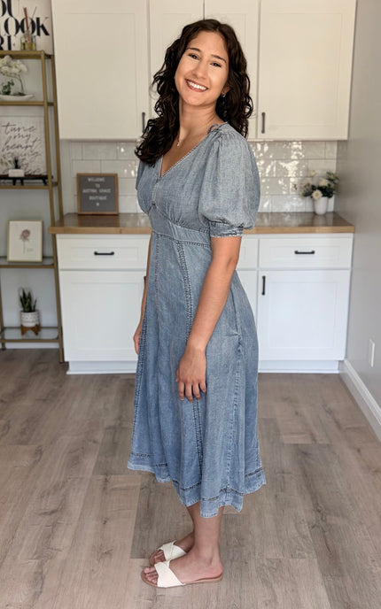Side profile of a 5'8" model wearing a size medium Tencel maxi dress, highlighting the fluid movement and airy fit of the tiered skirt.