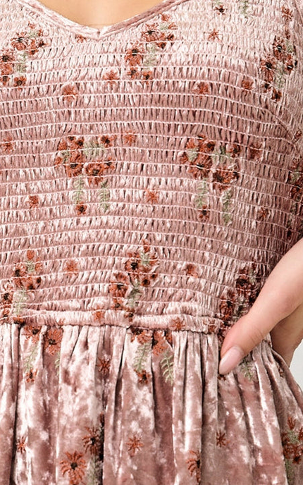 Woman wearing a floral dress with a plain background