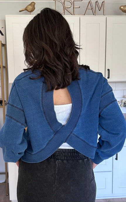 Denim-wash sweatshirt featuring modern cutout back detail