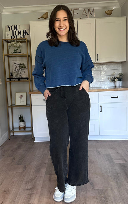 Oversized denim-wash sweatshirt layered over a tank for casual wear