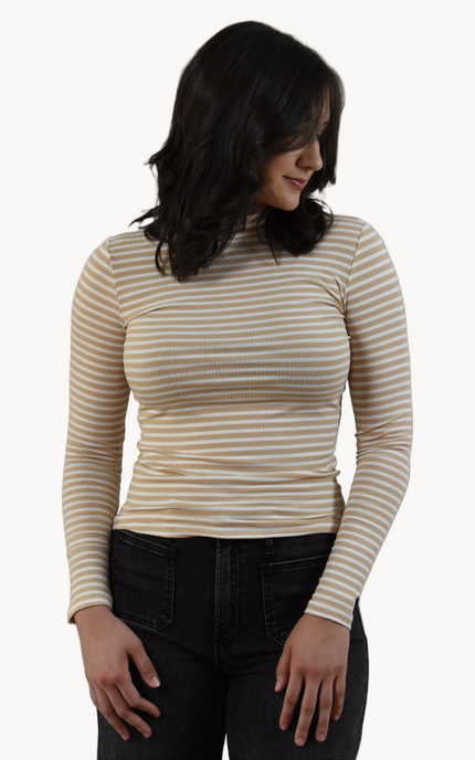 Woman wearing a striped long-sleeve top against a plain background