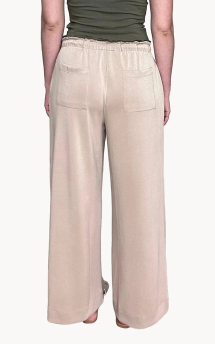 Back view of ruffle waist wide leg pants with back pocket detail