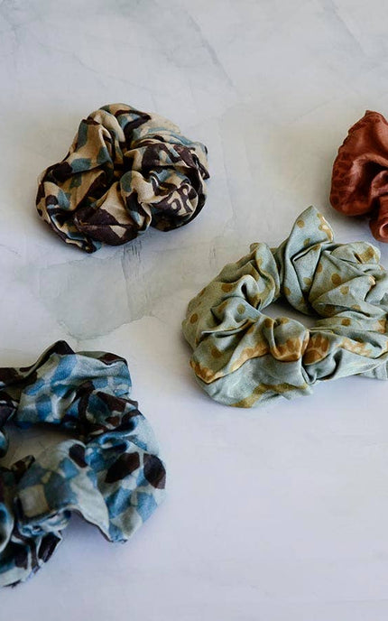 Hand-dyed satin finish scrunchies made from upcycled bandana fabric in soft earthy tones