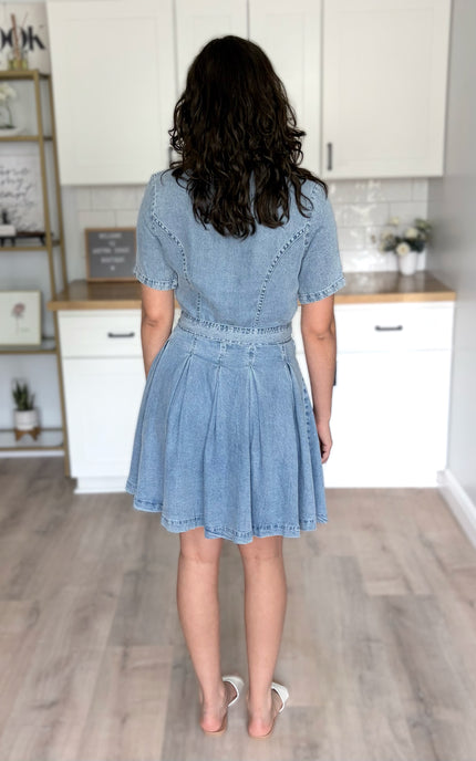 Back view of light-wash shirt dress showing clean lines and button-back detail