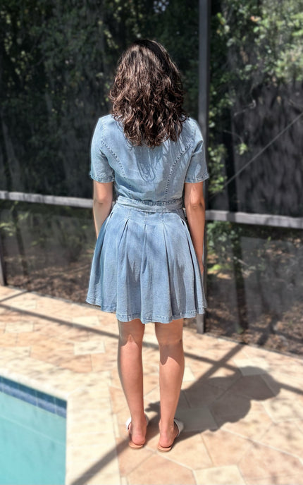 Back of light-wash shirt dress showing structured fit and relaxed silhouette