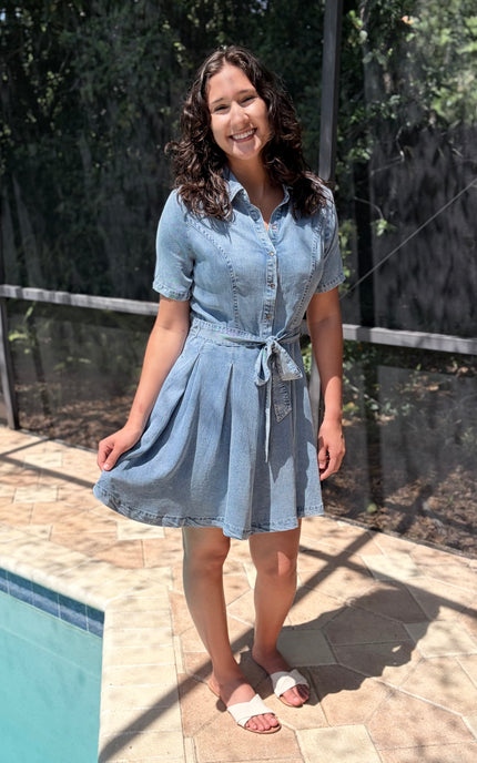 Tie waist detail on light-wash shirt dress allowing customizable fit