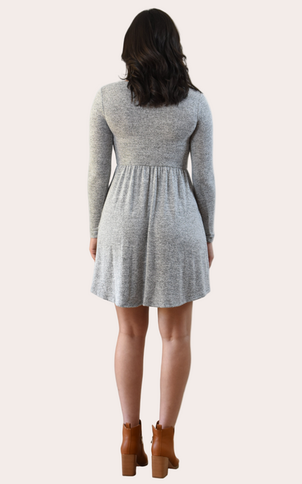 Woman wearing a gray dress with long sleeves on a white background