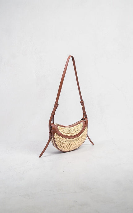 Modern crescent-shaped crossbody bag featuring sculpted silhouette and textured detail