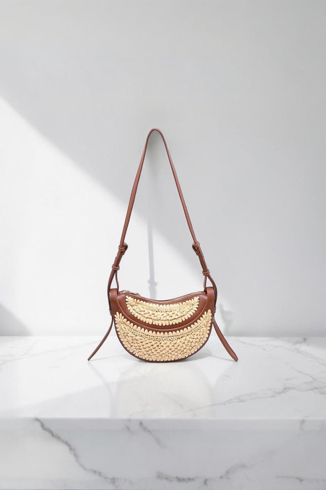 Sloane Crescent Crossbody Bag in vegan leather with woven front panel, flat lay view