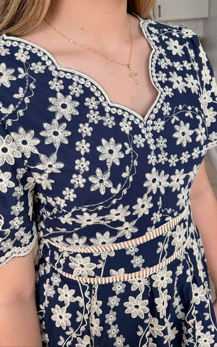 Detailed view of Sloane embroidered cotton floral midi dress with feminine flowy silhouette
