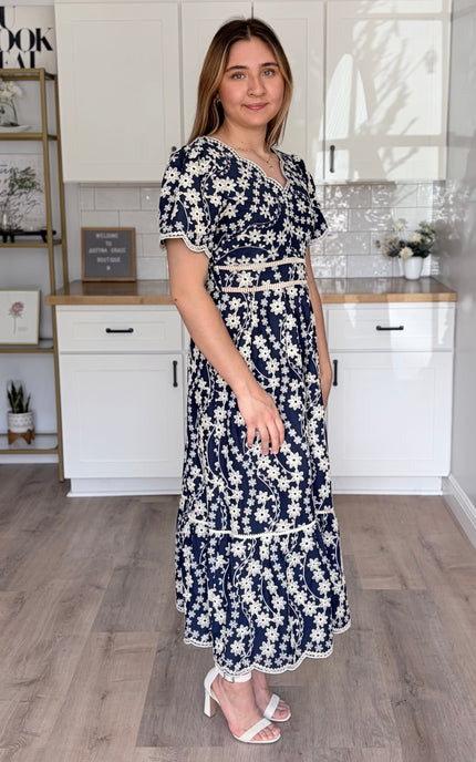 Side view of Sloane embroidered cotton floral midi dress with feminine flowy silhouette