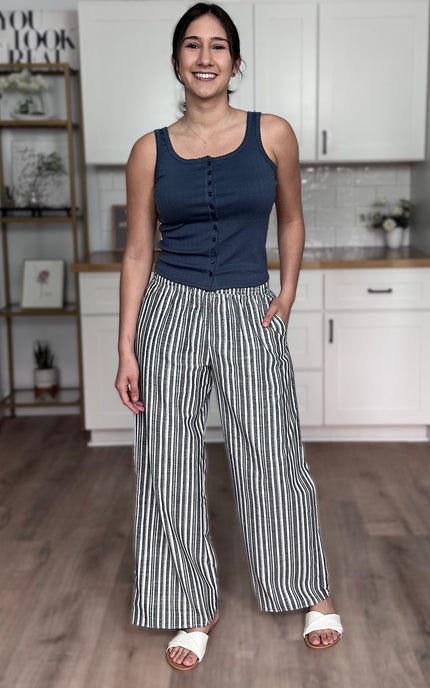 Side view of striped linen wide leg pants showing wide leg silhouette