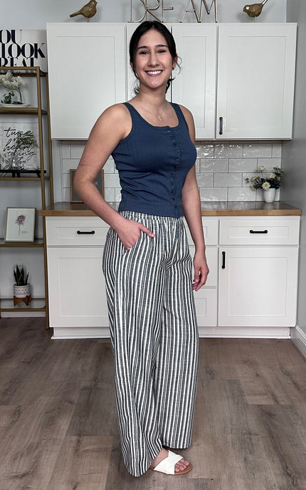 Side view of striped linen wide leg pants showing wide leg silhouette