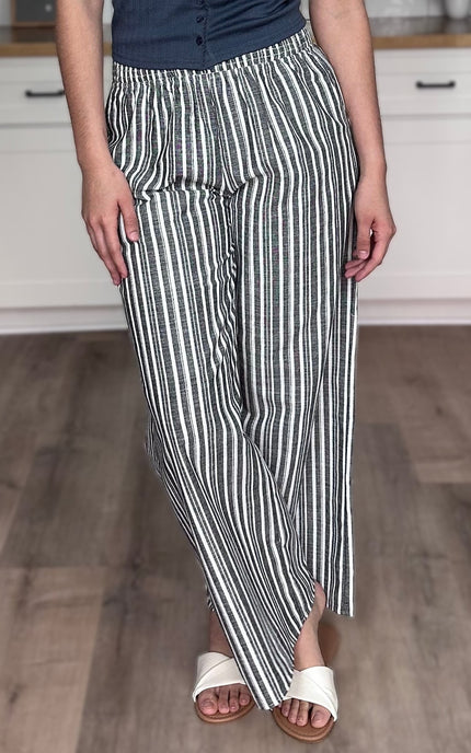 Side view of striped linen wide leg pants showing wide leg silhouette