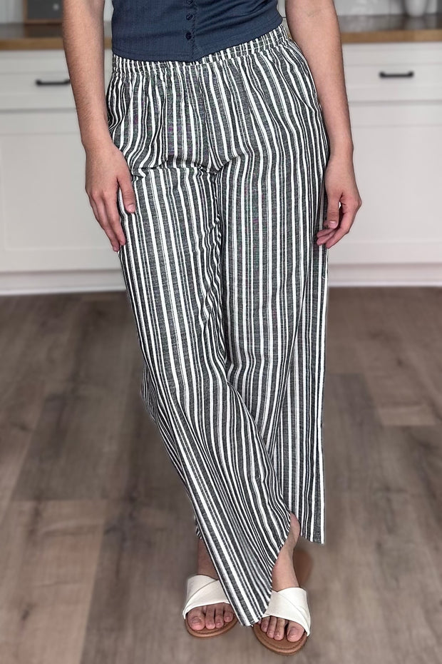 Side view of striped linen wide leg pants showing wide leg silhouette