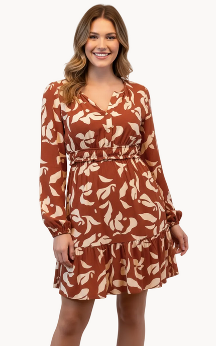 Woman wearing a brown floral dress on a white background