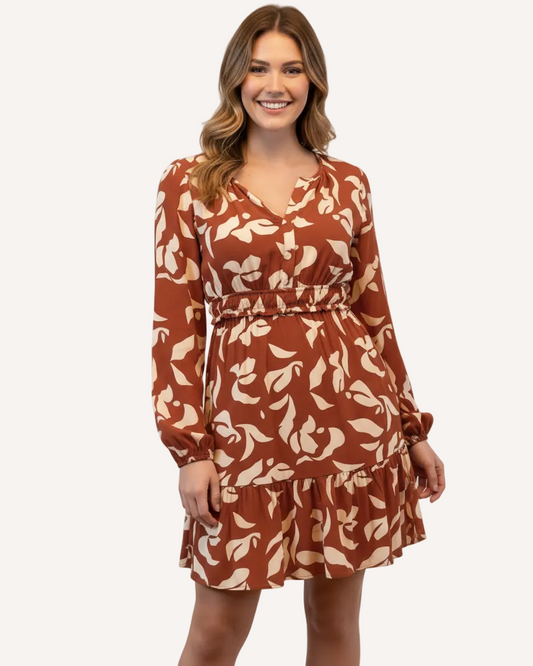 Woman wearing a brown floral dress on a white background