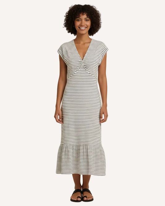 Woman wearing a striped dress on a plain background