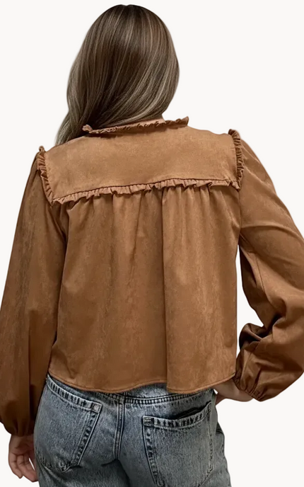 Brown suede-inspired cropped jacket top with ruffle trim, front cut-out, and balloon sleeves, shown on a soft-linen background for a cozy fall look.