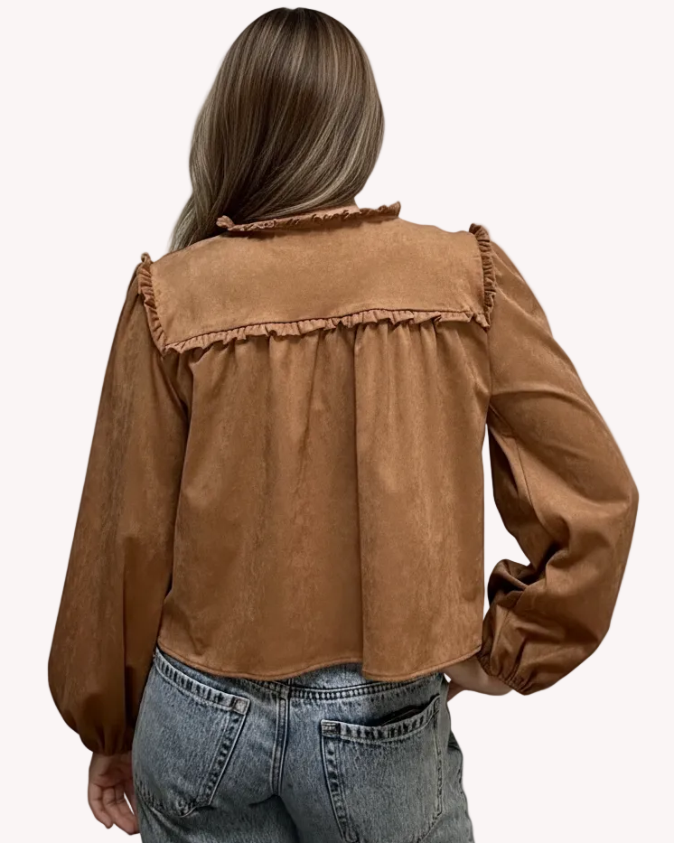 Brown suede-inspired cropped jacket top with ruffle trim, front cut-out, and balloon sleeves, shown on a soft-linen background for a cozy fall look.