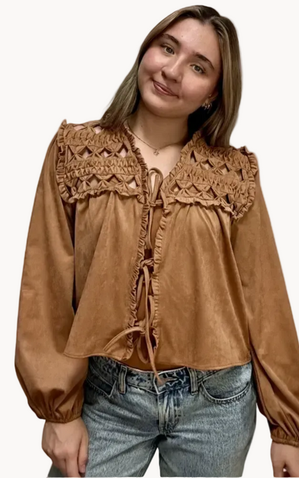 Brown suede-inspired cropped jacket top with ruffle trim, front cut-out, and balloon sleeves, shown on a soft-linen background for a cozy fall look.