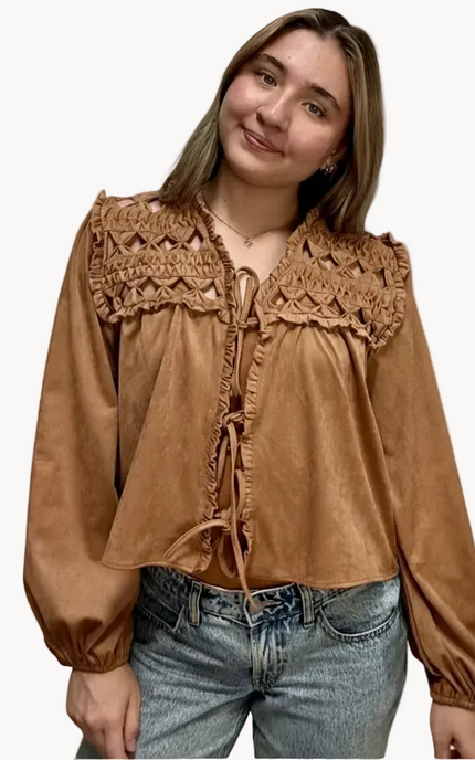 Brown suede-inspired cropped jacket top with ruffle trim, front cut-out, and balloon sleeves, shown on a soft-linen background for a cozy fall look.