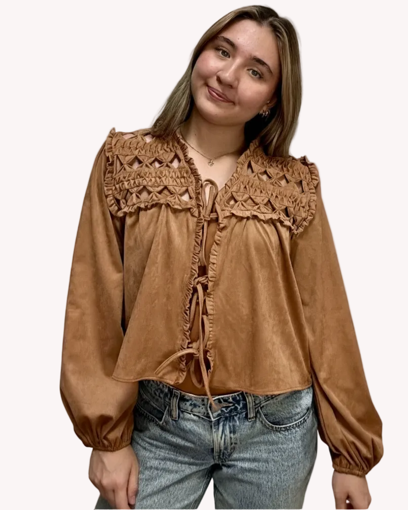 Brown suede-inspired cropped jacket top with ruffle trim, front cut-out, and balloon sleeves, shown on a soft-linen background for a cozy fall look.
