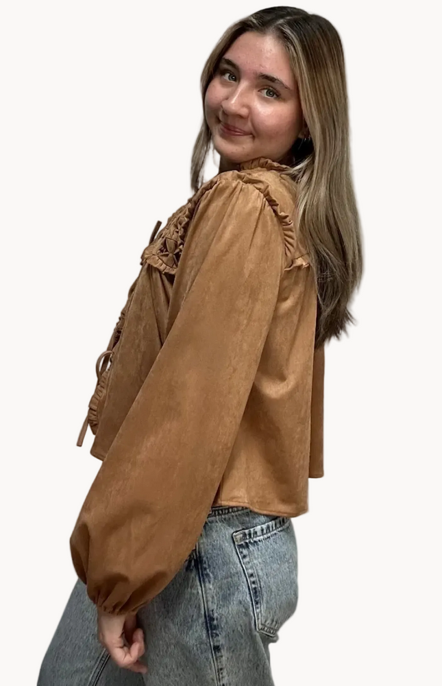 Brown suede-inspired cropped jacket top with ruffle trim, front cut-out, and balloon sleeves, shown on a soft-linen background for a cozy fall look.