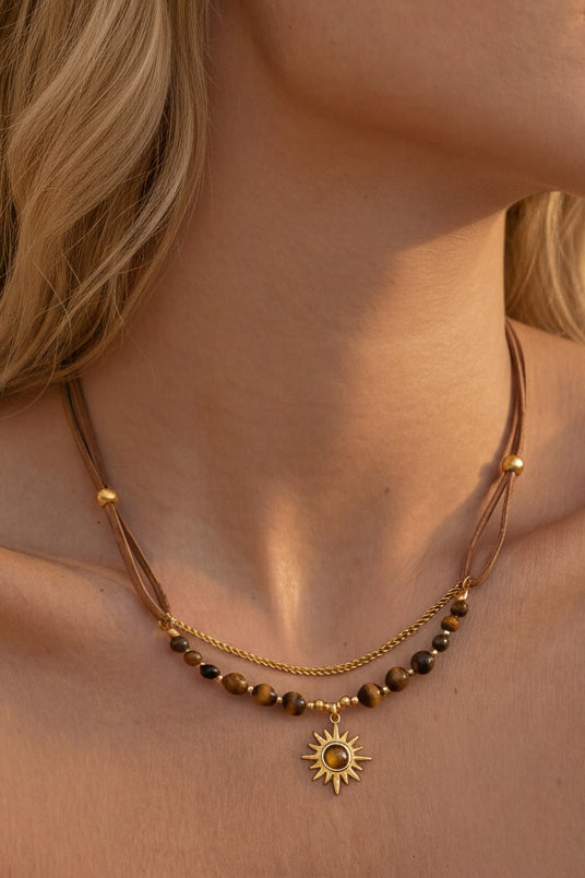 Beaded sun necklace on neck displaying symbolic, timeless aesthetic
