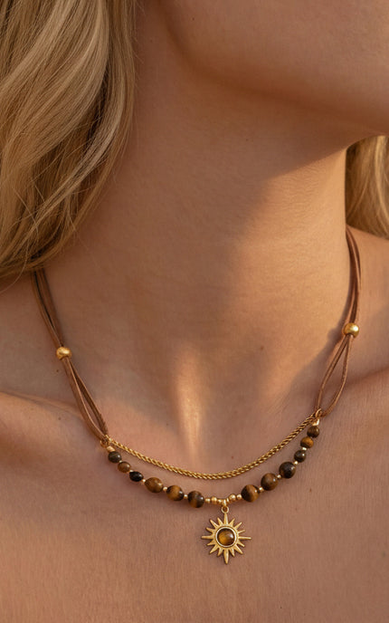 Beaded sun necklace on neck displaying symbolic, timeless aesthetic