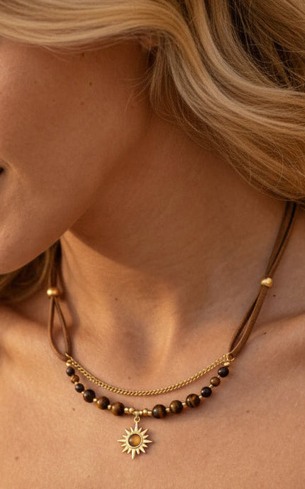 Gold PVD sun pendant necklace worn, demonstrating lightweight comfort and light-catching glow