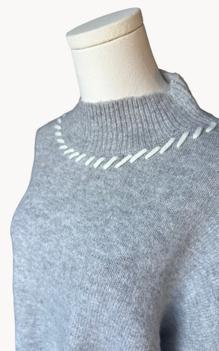 Heather grey crew-neck sweater with soft contrast stitching along the neckline and sleeves, midweight knit with stretch, photographed on a Soft Linen background for Justyna Grace Boutique.