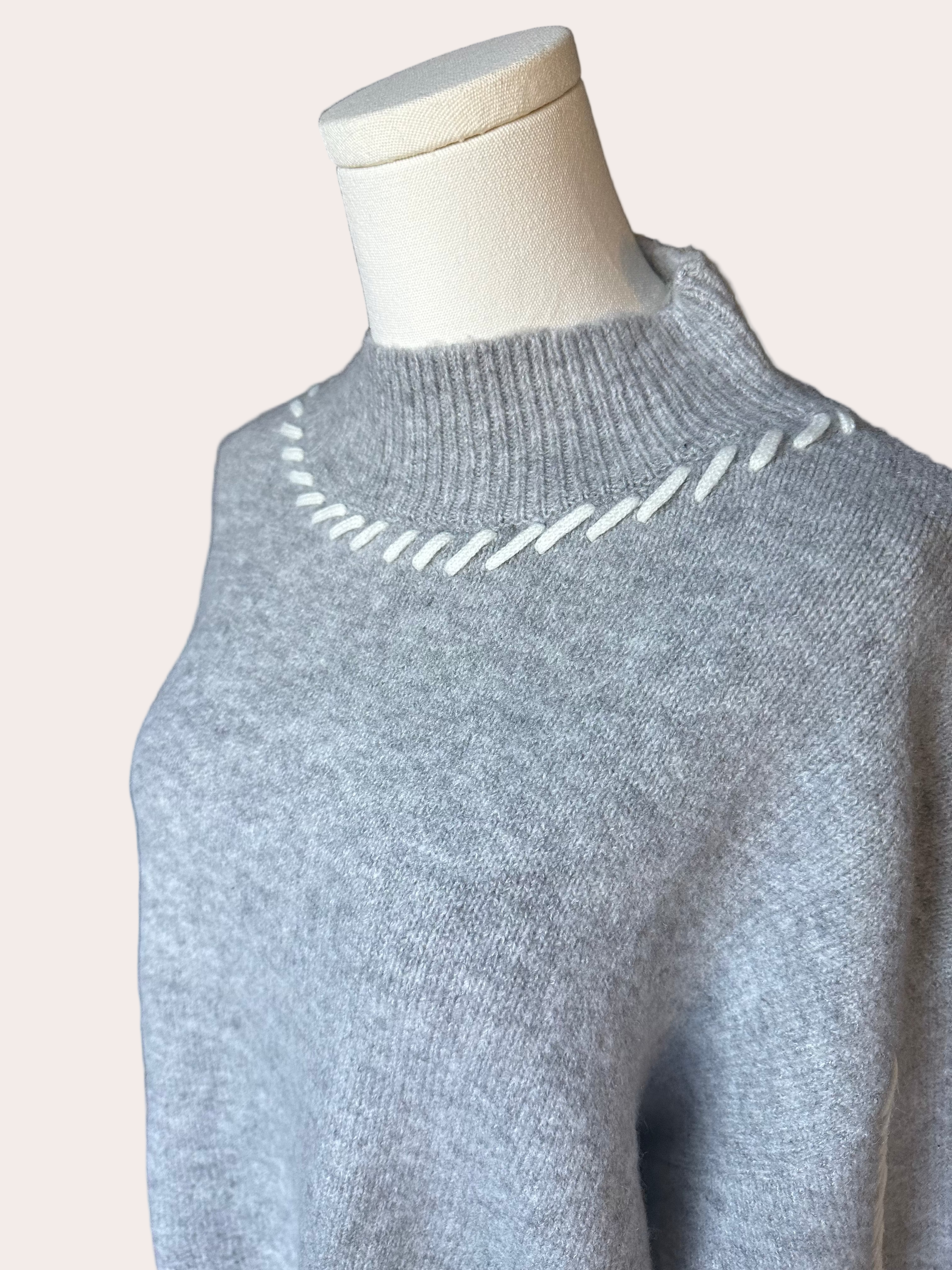 Heather grey crew-neck sweater with soft contrast stitching along the neckline and sleeves, midweight knit with stretch, photographed on a Soft Linen background for Justyna Grace Boutique.