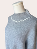 Heather grey crew-neck sweater with soft contrast stitching along the neckline and sleeves, midweight knit with stretch, photographed on a Soft Linen background for Justyna Grace Boutique.