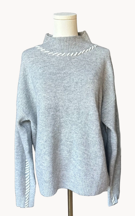 Heather grey crew-neck sweater with soft contrast stitching along the neckline and sleeves, midweight knit with stretch, photographed on a Soft Linen background for Justyna Grace Boutique.